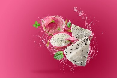 water splashing on dragon fruit or pitaya over pink background.