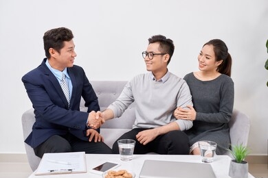 real estate agent working with clients in office