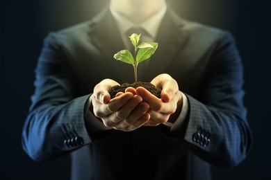 businessman with seedling in his hands