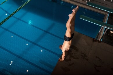 sportsman in swimwear working out near swimming pool