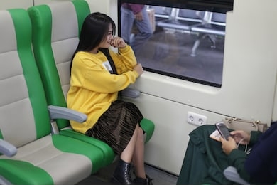 asian woman train. asian woman sitting in subway