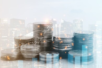 double exposure of city view , diagram bar and line graph , rows of coins for finance , money , investment and business concept background