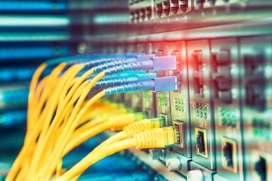 fiber optic cables connected to an optic ports and network cables connected to ethernet ports