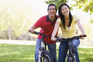 couple on bikes outdoors smiling