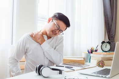 asian business men are suffering from work-related pain from office syndrome.
