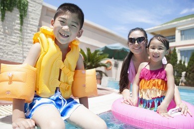 family portrait by the pool with pool toys