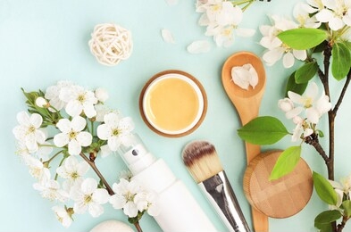 beauty spa treatment, honey facial mask, skincare cosmetic products with natural spring apple blossom top view over pastel colored blue delicate background