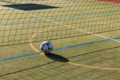 outdoor playground for tennis, volleyball and football. net and soccer ball on the playground. futnet.