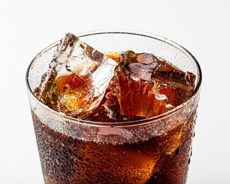 ice cold refreshing carbonated summer drink with ice chunks in a glass.
