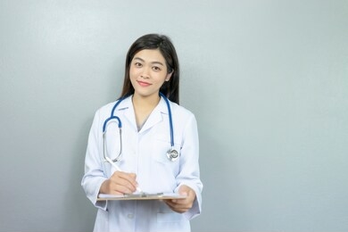 female doctor,surgeon,nurse,pharmacy with stethoscope on hospital holding clipboard,writing a prescription,medical exam,healthcare and medical concept,test results,vintage color,selective focus