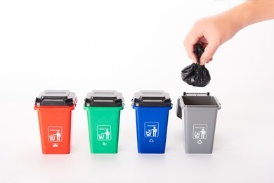 garbage classification of color garbage cans on white background