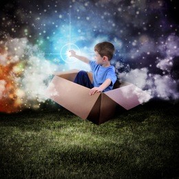 a young boy is sitting in a cardboard box and floating in the night sky reaching for a star in space.