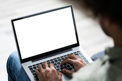 close-up of young man working on laptop at home