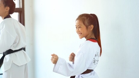 teacher teaching taekwondo girl, korean martial art