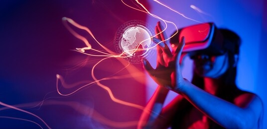 young woman using glasses of virtual reality on dark background. smartphone using with vr headset,virtual reality,future technology concept.asian woman using vr glasses in colorful neon lights.