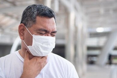 allergic sick old man having sore throat inflammation; concept of man with allergy, phlegm, sore throat or throat inflammation, influenza, flu, cold, sickness, air pollution health care concept