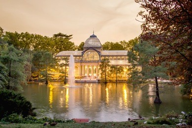 buen retiro park lake in madrid with the famous crystal palace on background