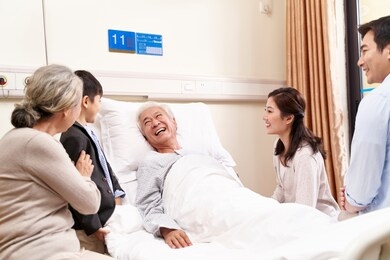asian family with child visiting grandparents in hospital