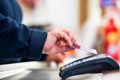 close up of cashier is using contactless credit card pos terminal to getting the payment. 
