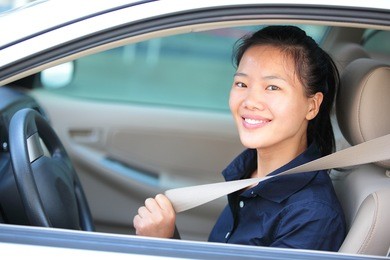 woman driver buckle up the seat belt before driving car