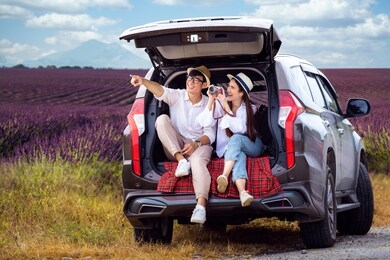 asian couple travel by a car in lavender field, this image can use for travel, tour, love and valentine day concept