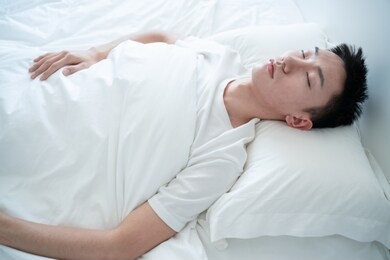 side view of bearded man sleeping on bed