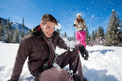 young couple having fun in snow,  outside