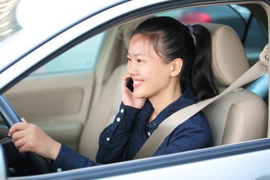  beautiful asian woman driving car and one the phone
