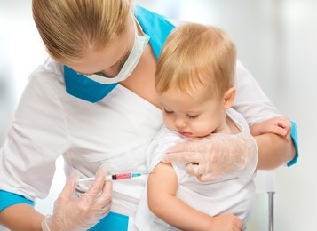 a doctor does injection child vaccination baby