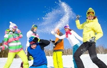 group of friends have a snowball fight