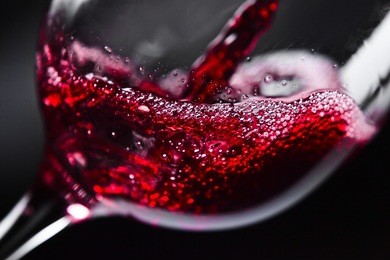  red wine in wineglass on  black background