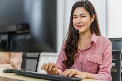 call center operators. beautiful asian woman working service consulting clients with headset and computer in workplace service center.