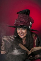 halloween witch casting spells on red background
