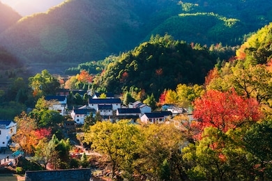 ancient buildings in the mountains, reflecting the red leaves in autumn, chizhou city, anhui province, china.