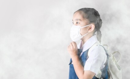 portrait asian children girl wear  mask to protect pm 2.5 dust and air pollution. portrait of thai student wearing protection mask  bad weather, pm2.5 concept background