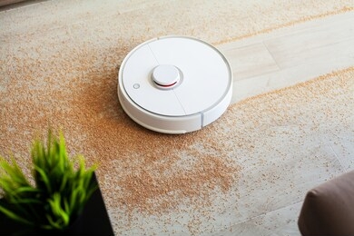 robot vacuum cleaner performs automatic cleaning of the apartment at a certain time. smart home
