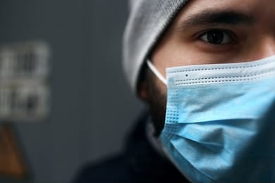 closeup portrait outdoors of a man in a medical mask who is sick with a virus. epidemic.