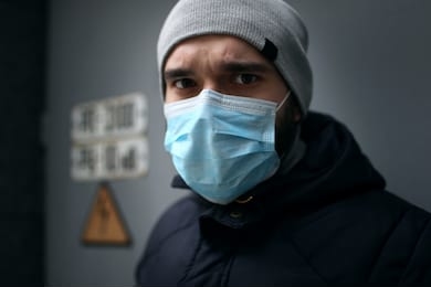 closeup portrait outdoors of a man in a medical mask who is sick with a virus. epidemic.