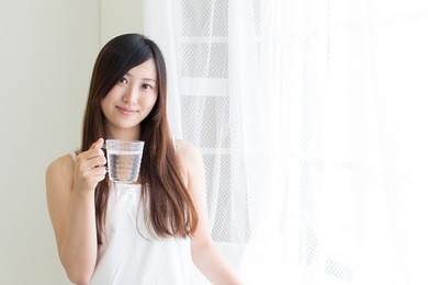 young asian woman relaxing in sunny room