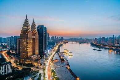 night view of golden high-rise buildings along the yangtze river in chongqing, china	