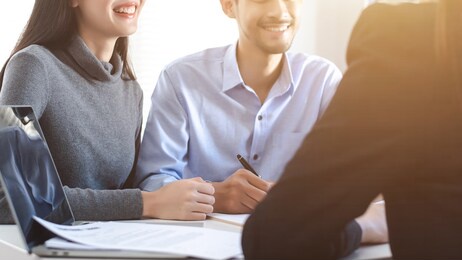 couples asian made signing real estate leases, they have smilly and happy faces.
