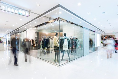 boutique display window with mannequins in fashionable dresses 