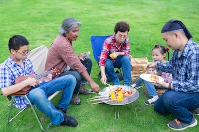 close up asian senior man, asian family picnic and cooking in garden, they grilling barbecue, they feeling happy in party activity, happiness family time