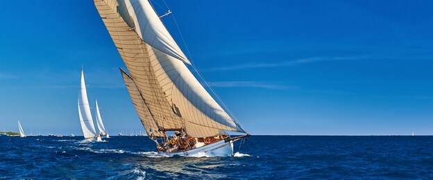 sailing yachts race in strong wind