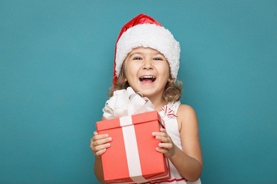 happy little smiling girl  with  christmas gift  box.