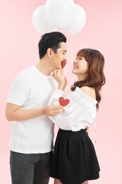happy lover couple with balloon and kissing heart paper shape. valentines day