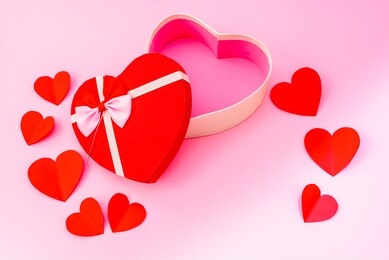 happy valentines day, valentines day background, opened heart shape gift box with ribbon and small paper hearts, on pink background, valentines day card - top view