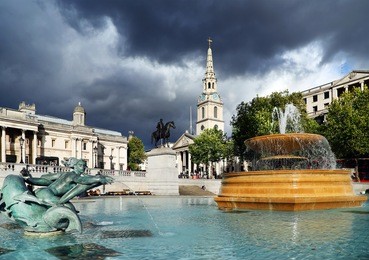 trafalgar square in london, england, europe - stormy background
