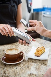customer paying for coffee using nfc technology