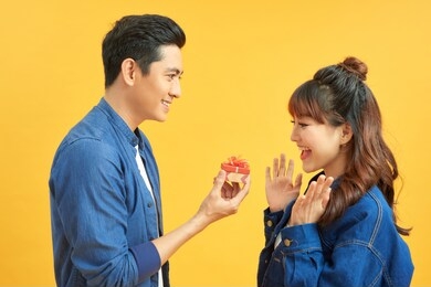 young handsome asian man surprisingly ask her girlfriend for proposal.